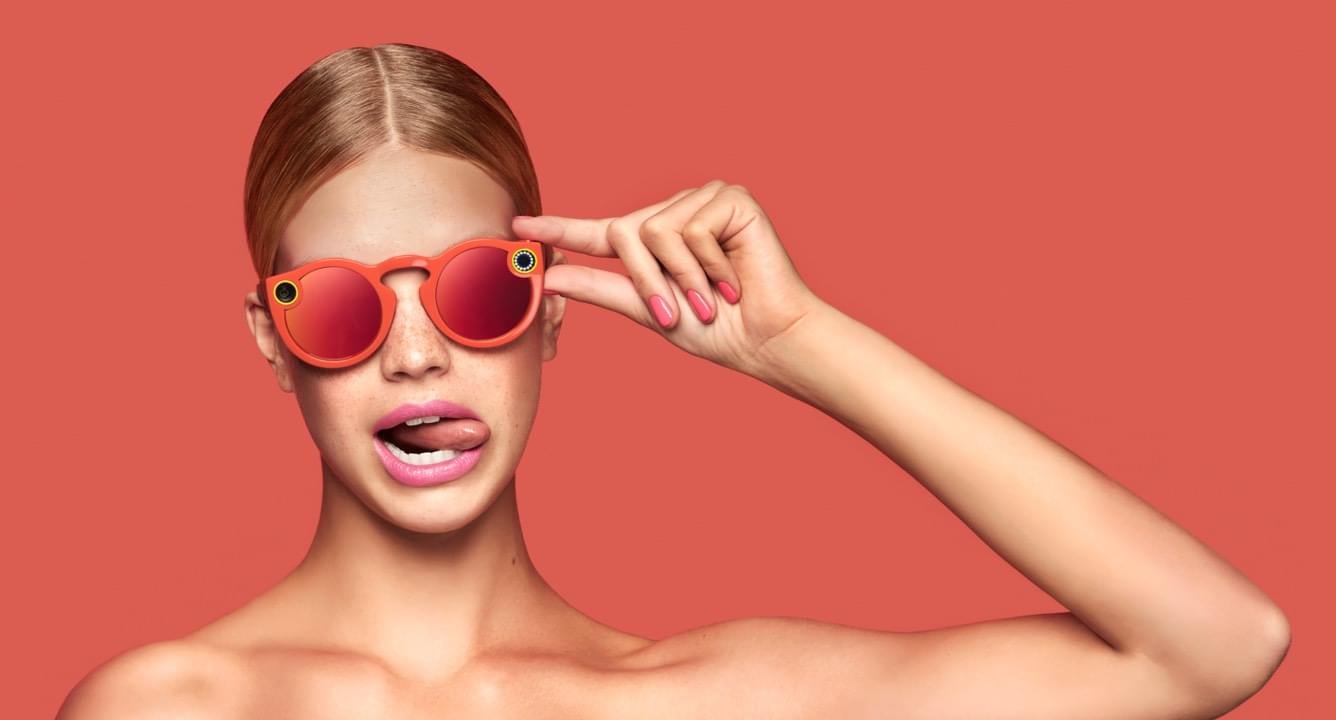 A woman wearing Snap's Spectacles.