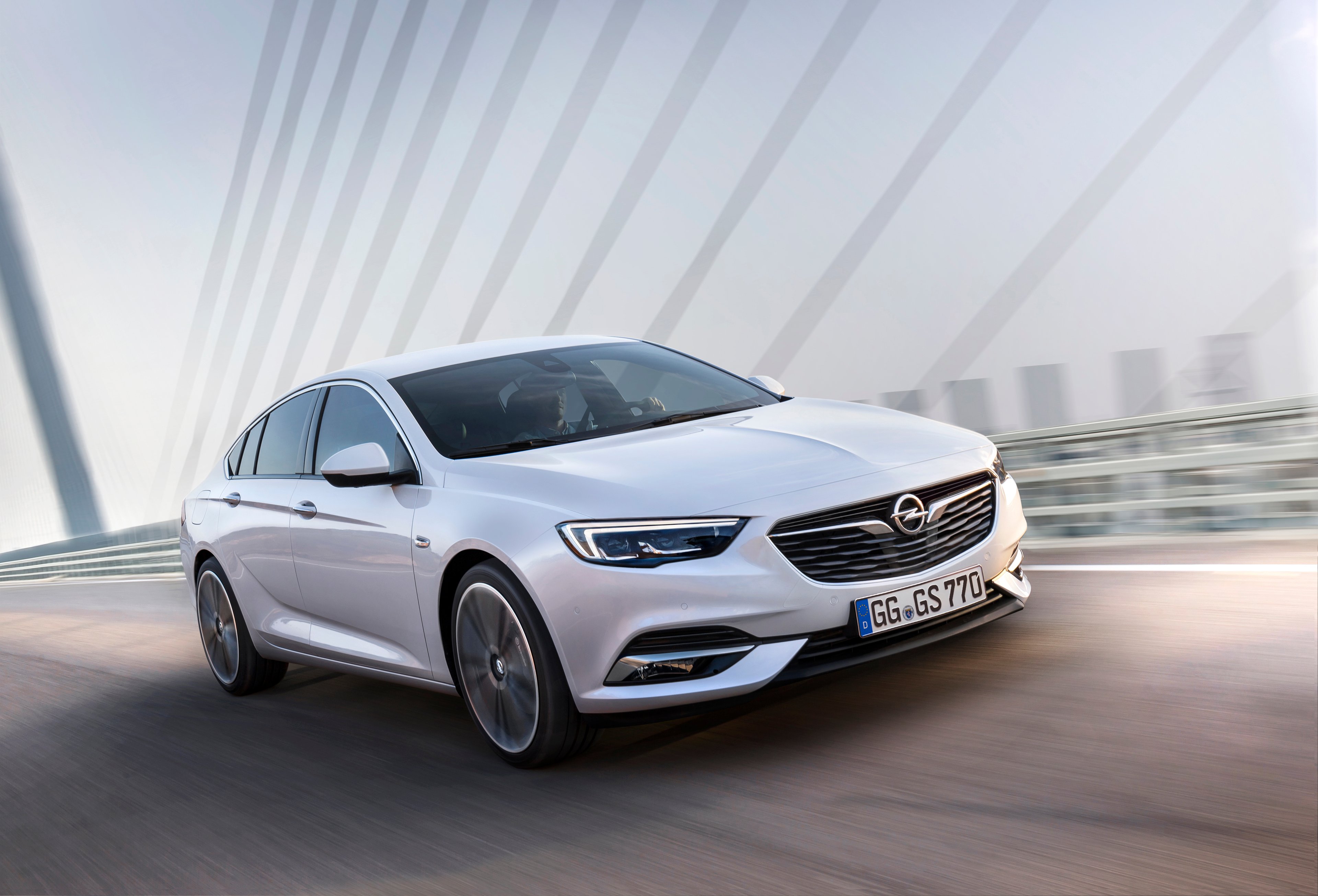 A white 2018 Opel Insignia sedan on the road. 