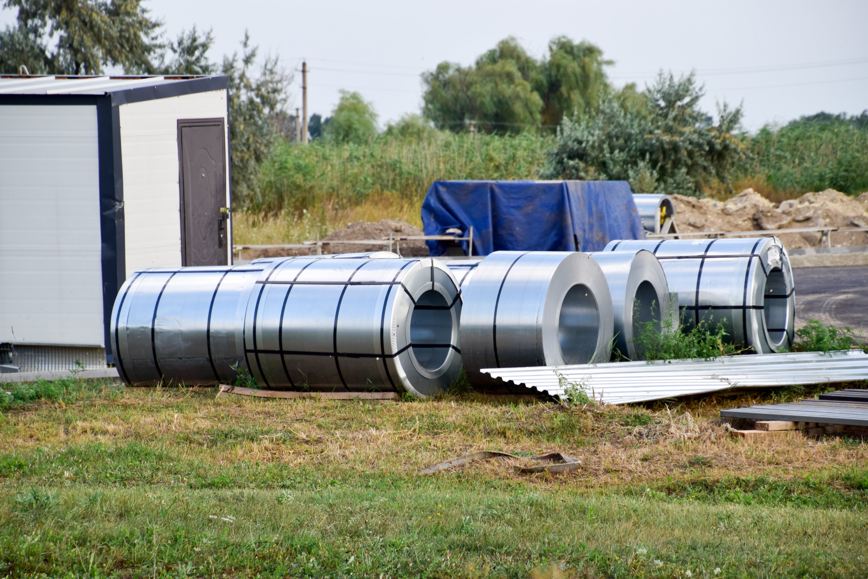 Sheet metal rolls in field.