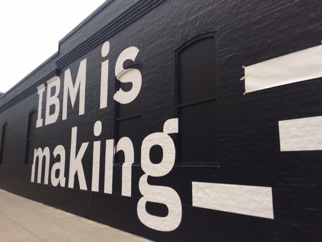 Mural of "IBM is making" printed on a wall.