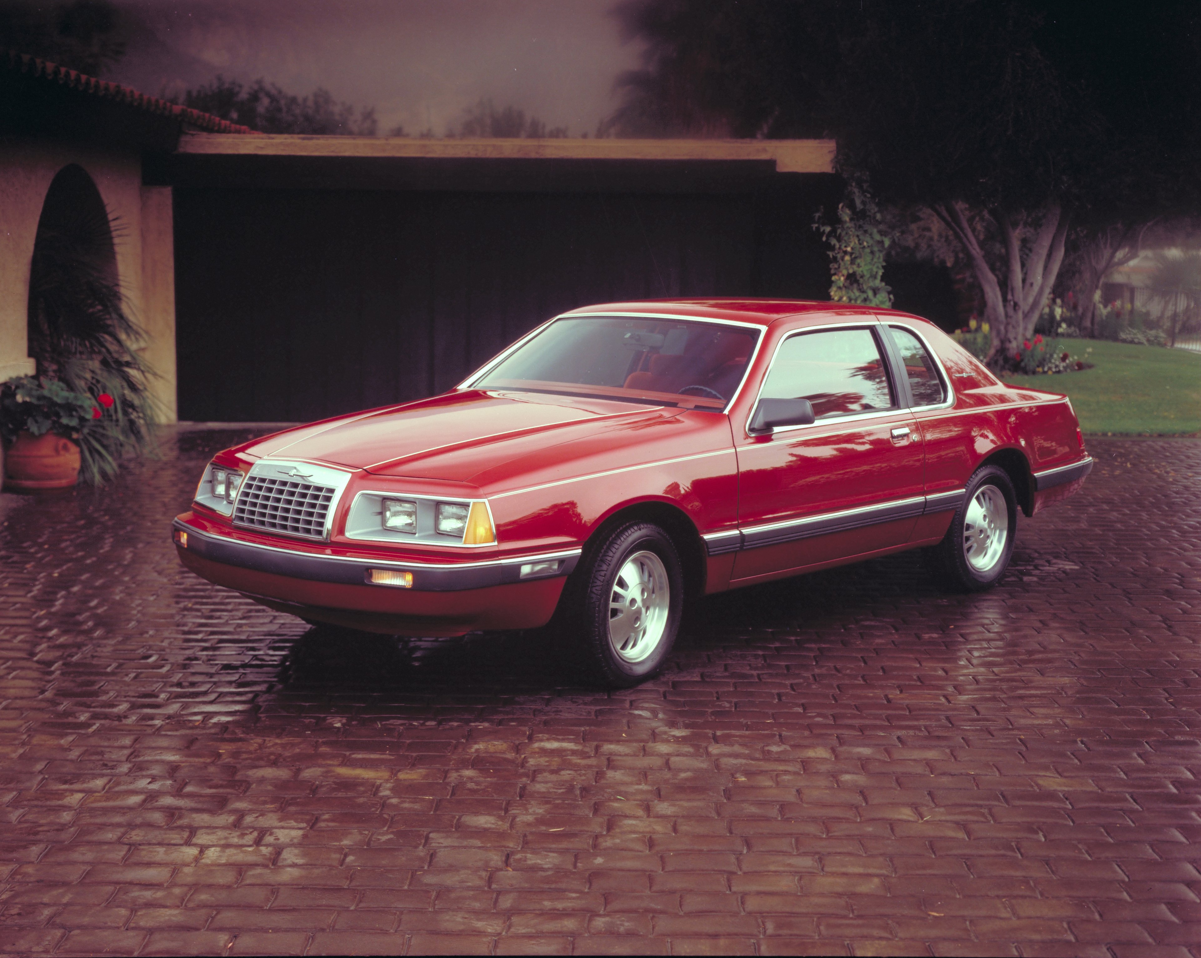 A red 1983 Ford Thunderbird.