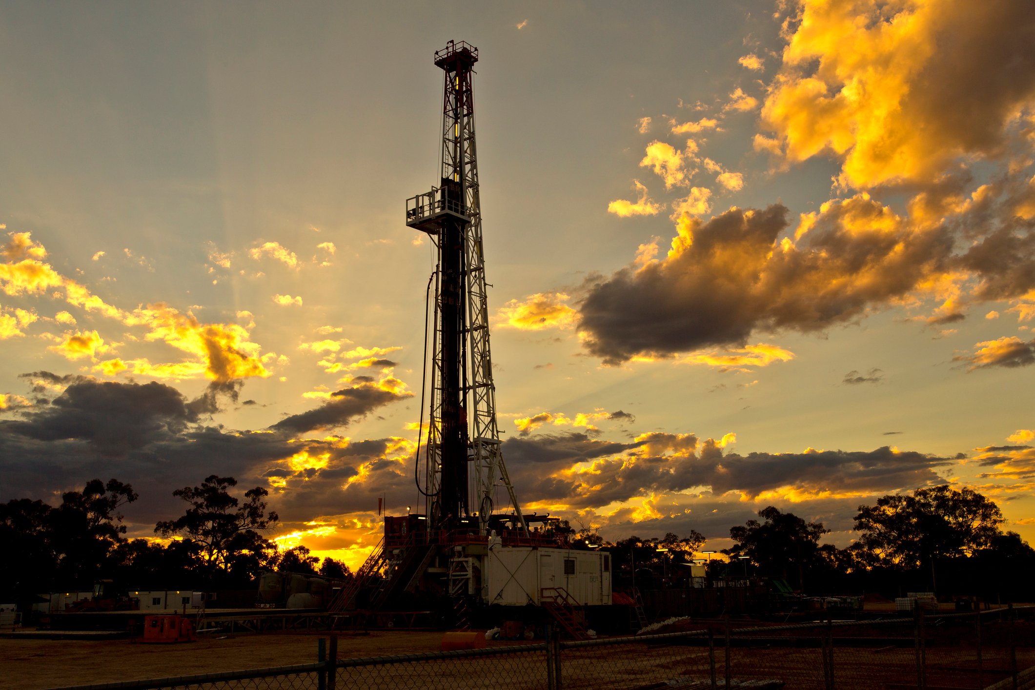 A land drilling rig at sunset. 