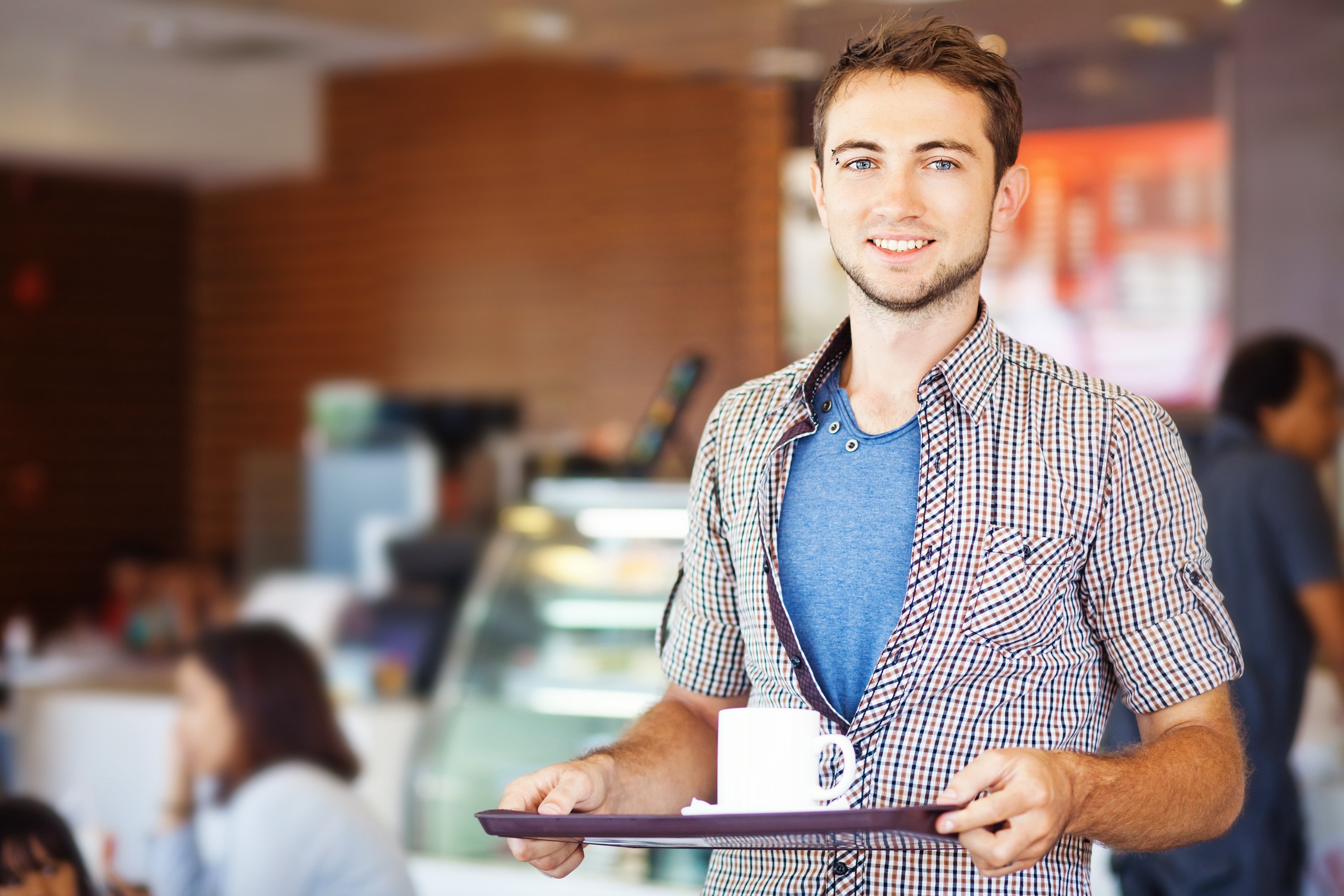 Man with a food tray in a fast casual restaurant.