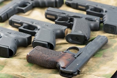 Gun Industry Pistols Arranged on a Table