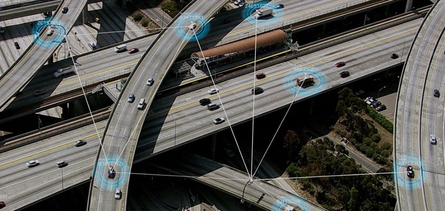 Picture of highway with technology encircling some cars.