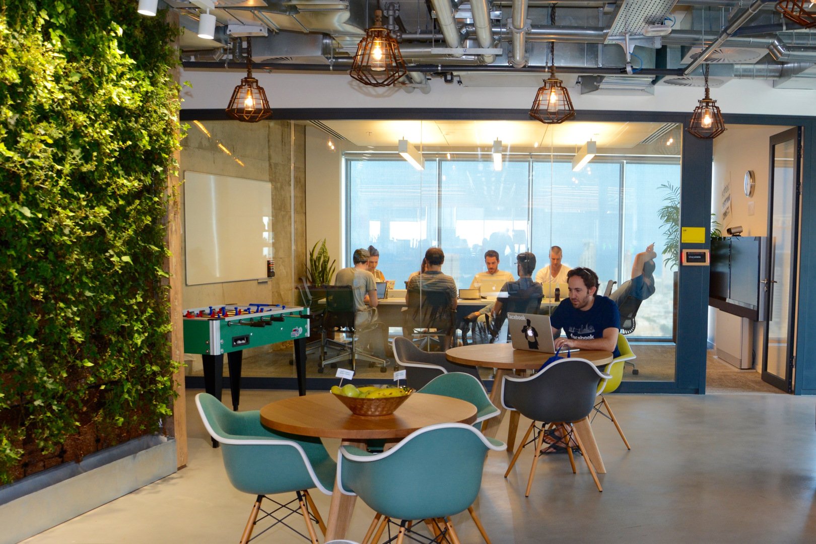 Workers meet in a conference room at Facebook's offices in Tel Aviv
