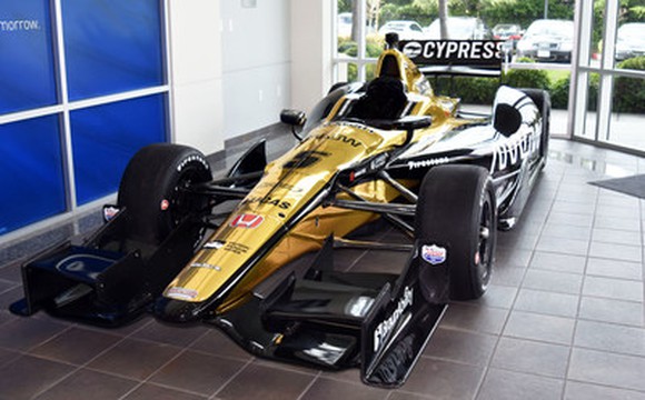 The IndyCar Honda No. 5. The gold car is parked in a garage with the name Cypress displayed on the rear spoiler.