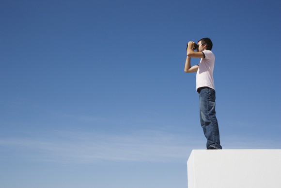 Man looking through binoculars. 