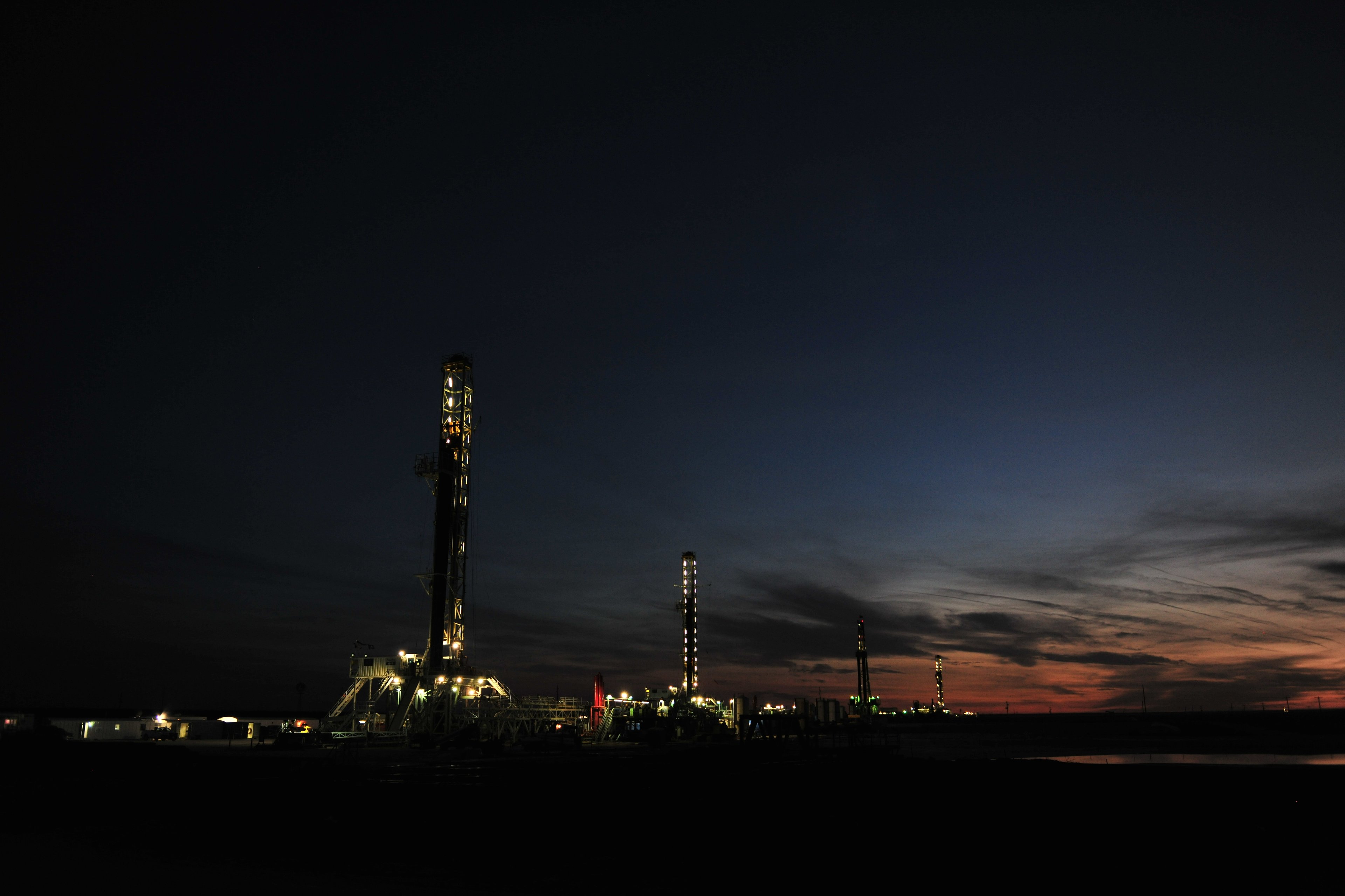Drilling rigs at dusk. 