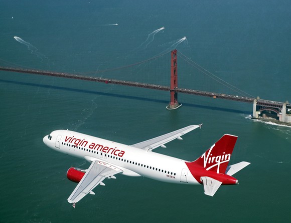 Virgin America plane flying near the Golden Gate bridge. 