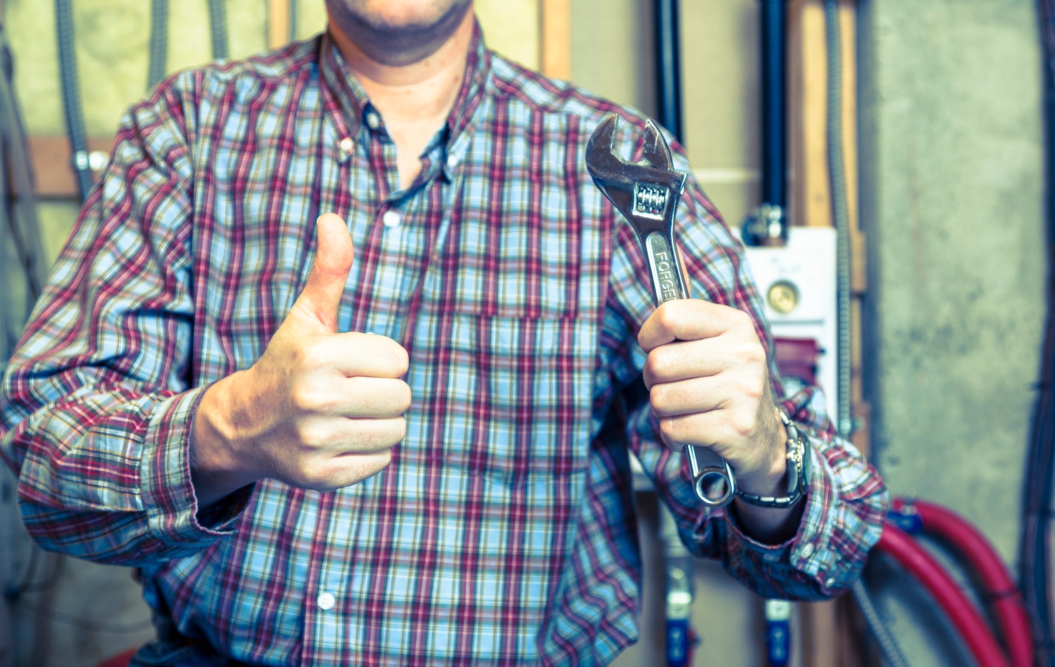 A handyman completes a project and gives a thumbs up.