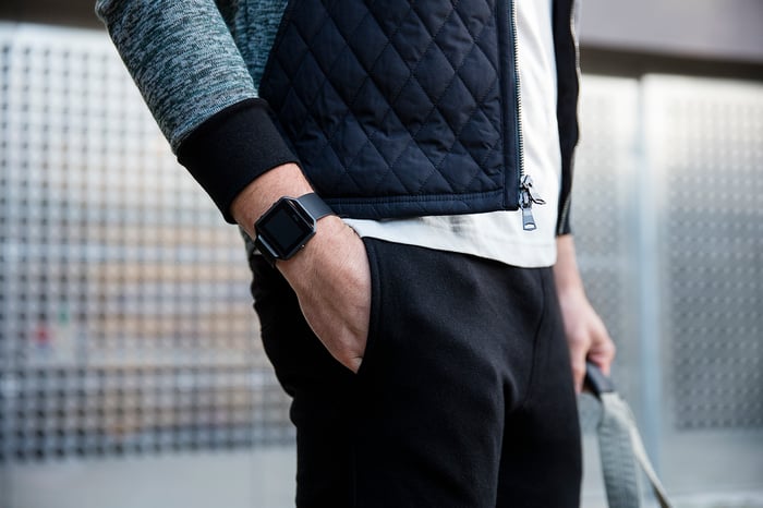 Man wearing a Fitbit Blaze waiting in a train station