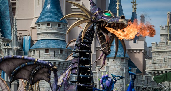 Dragon Maleficent breathing fire outside Cinderella's iconic castle.
