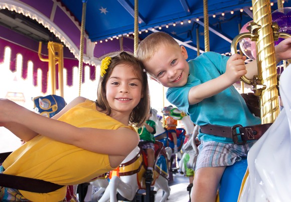Kids having fun on a Disneyland carousel.