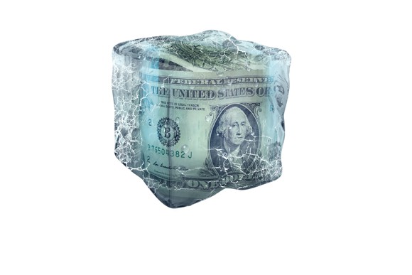 Dollar bills inside a block of ice
