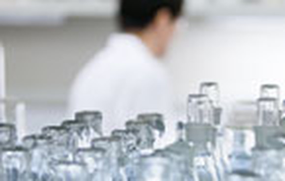 A lab worker prepares bottles containing marijuana-based medicines.