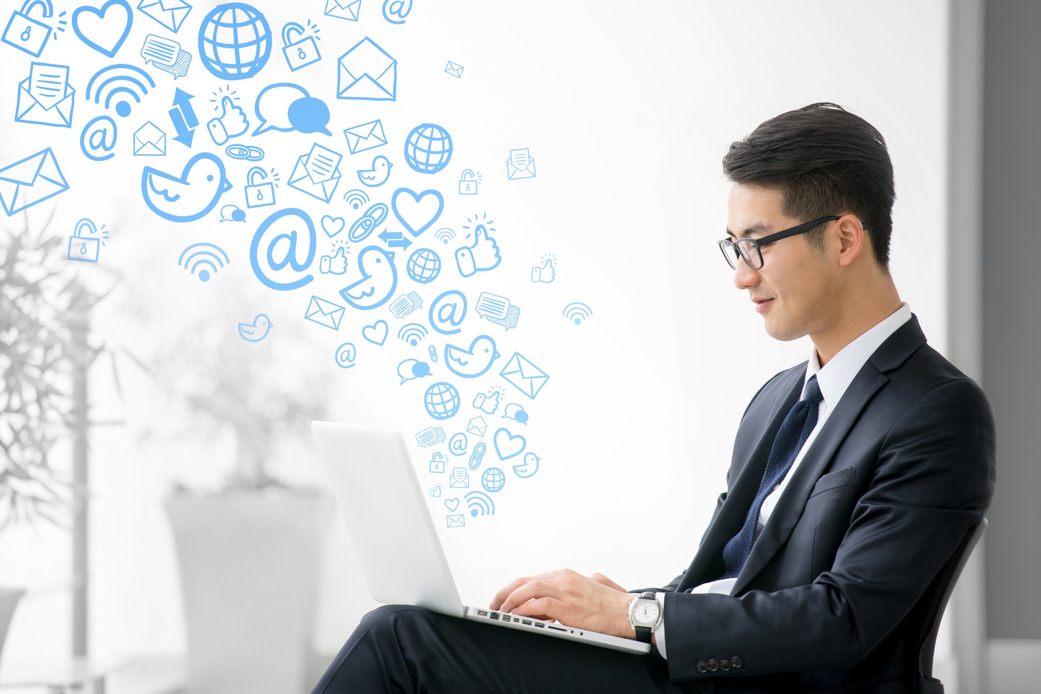 A young businessman using social media on his laptop.