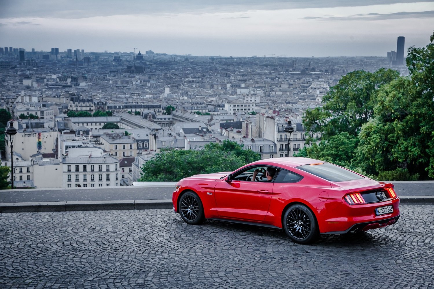 Ford's Mustang parked with a view of a French city.