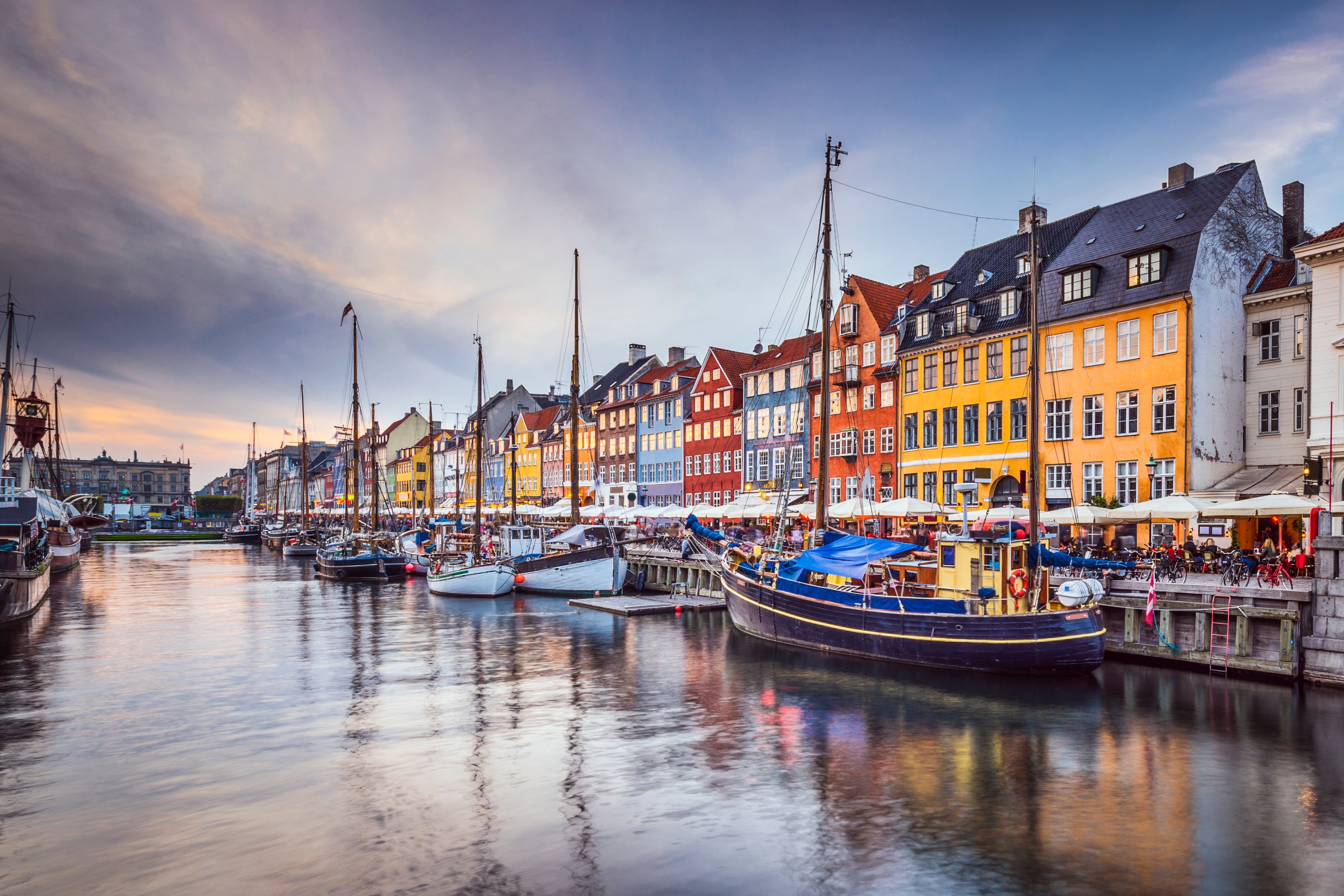 Colorful houses and some boats along the river in Copenhagen, Denmark.