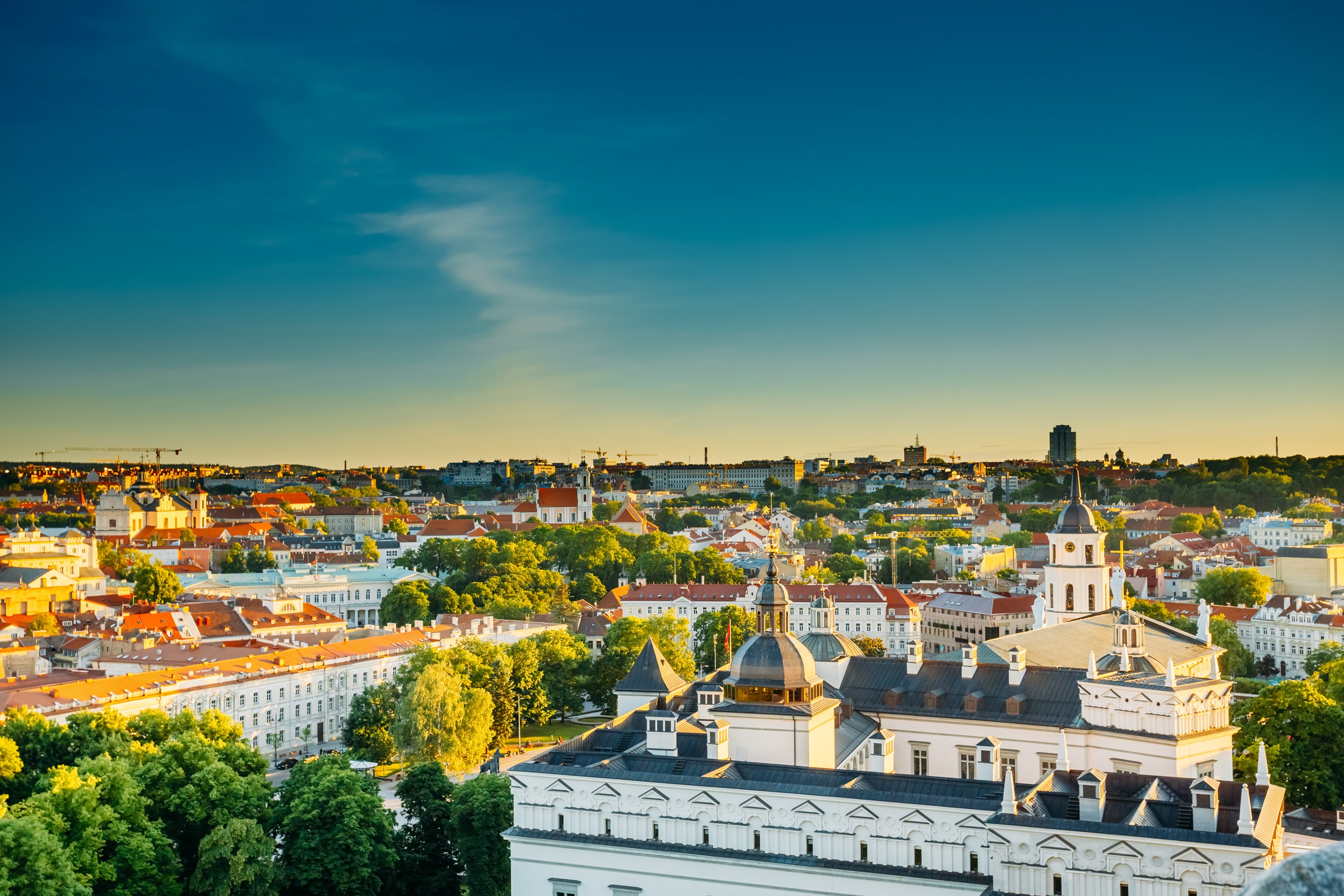 Sun setting over buildings in the old town of Vilnius, Lithuania.