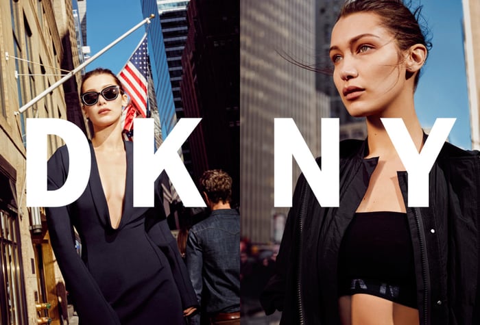 A woman posing in front of New York skyscrapers in a DKNY advertisement.