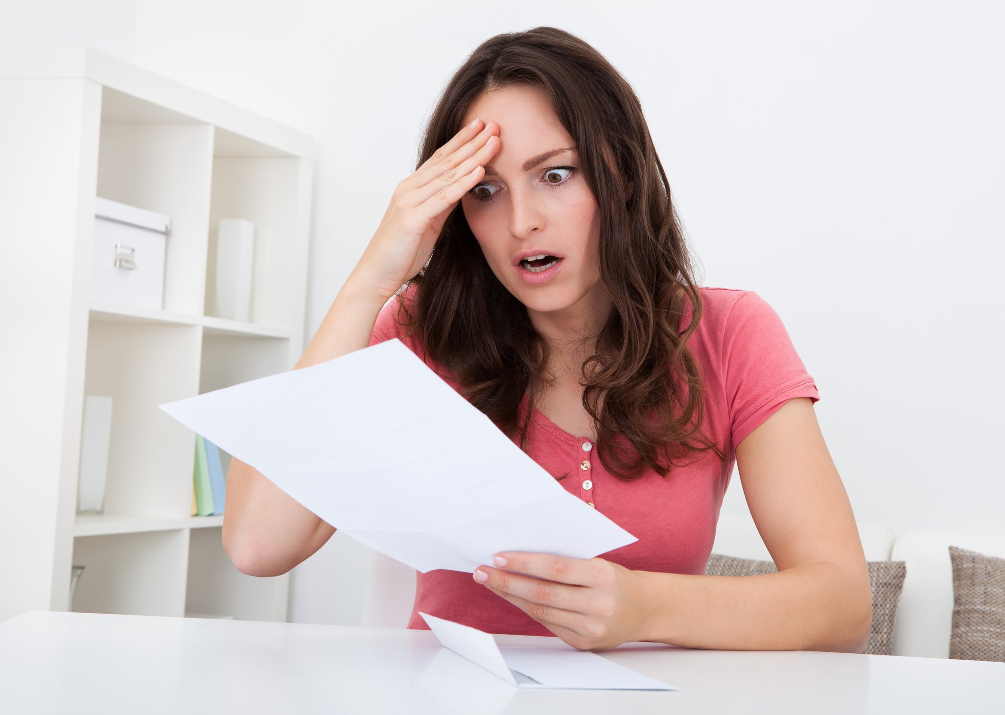 Woman looking shocked at tax bill
