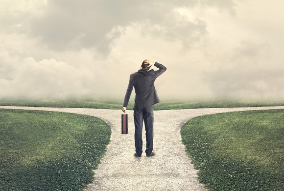 Man standing at crossroads, trying to decide which path to take. 