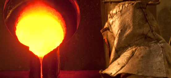 A Yamana Gold employee pouring liquid gold.