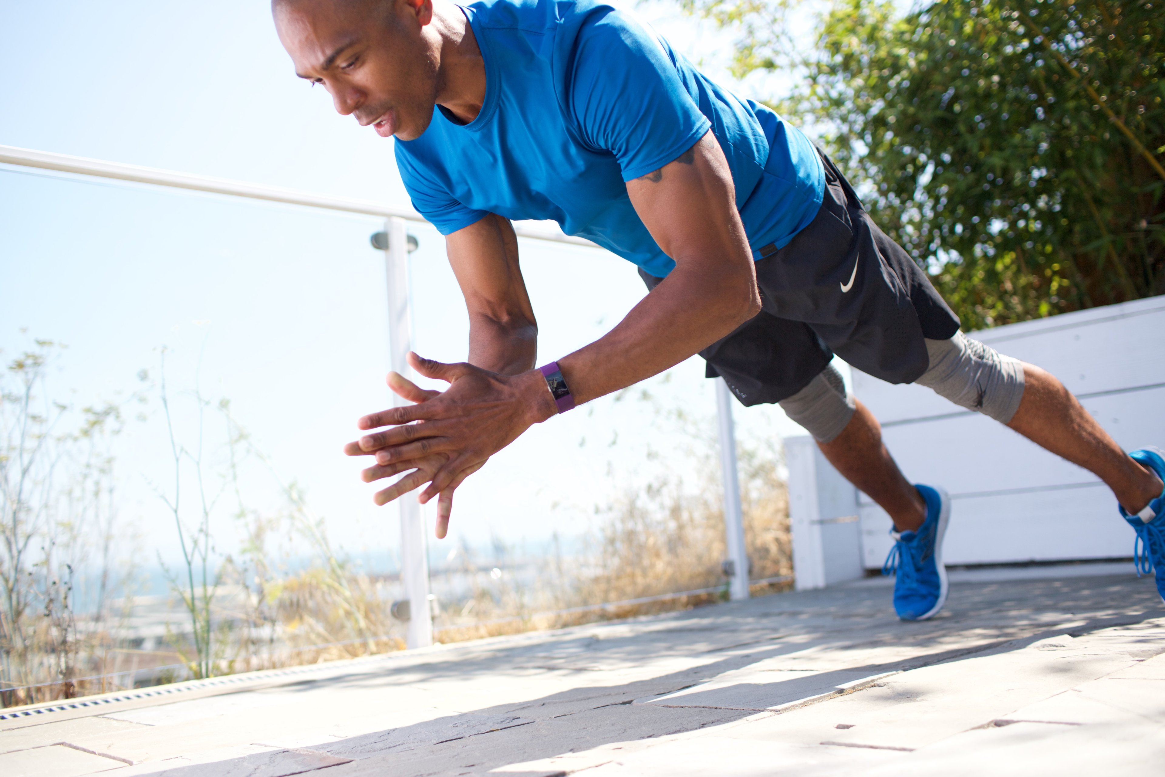 Male athlete performing clapping pushups with a Fitbit Blaze on his wrist