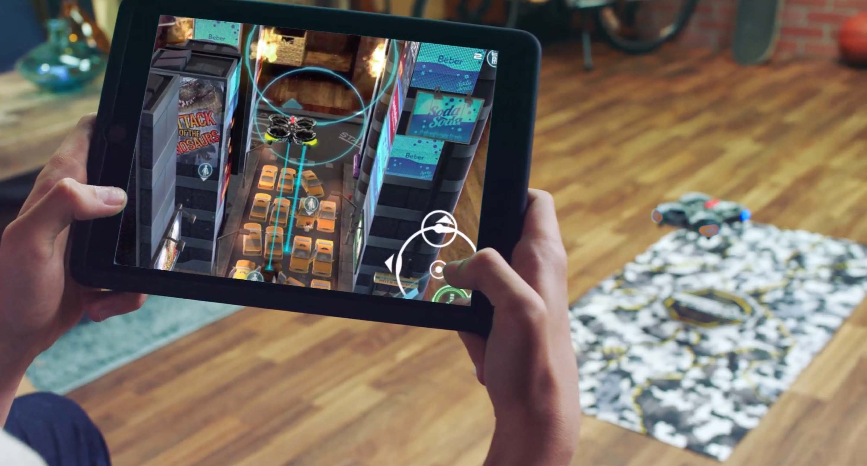 A young boy using a tablet to control a drone that is sold through GameStop's ThinkGeek chains.