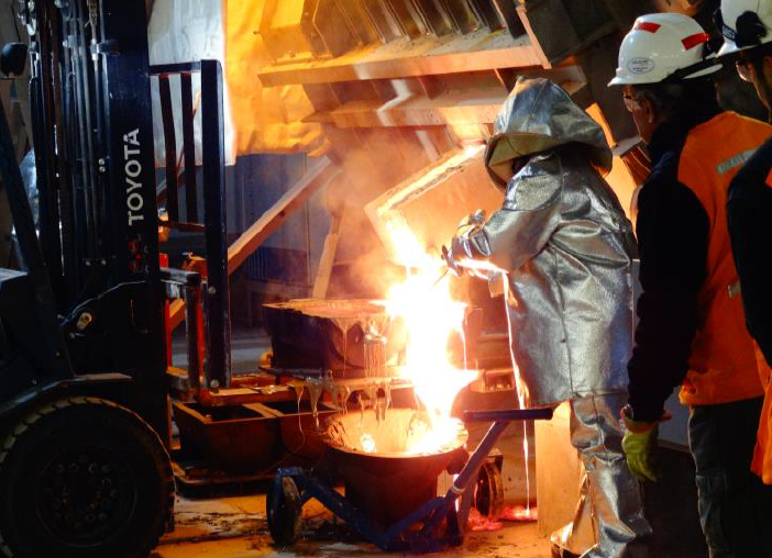 A Goldcorp employee pours melted gold.