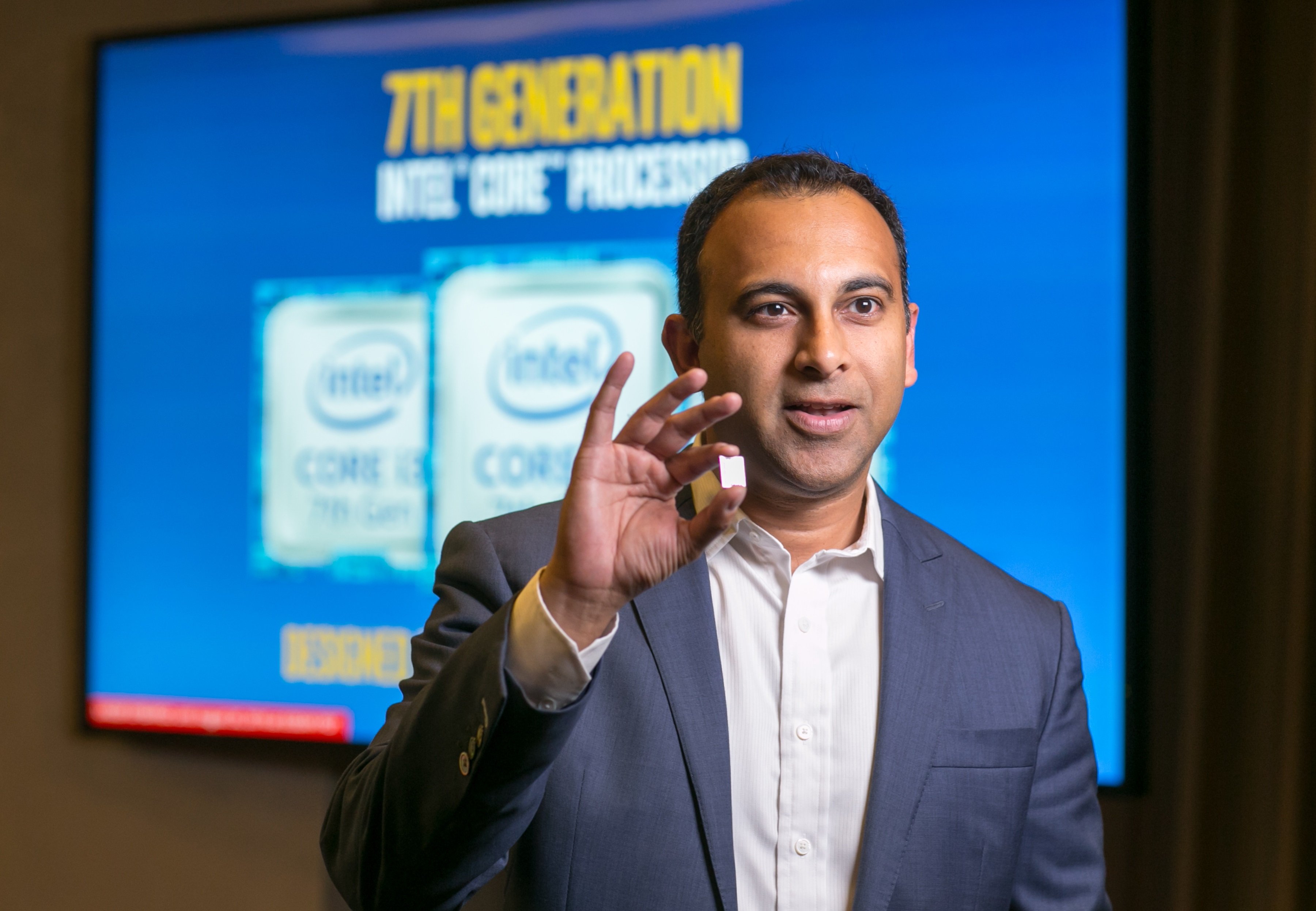 Intel executive Navin Shenoy holding up a seventh-generation Core chip. 