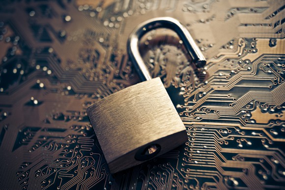 A padlock placed on a circuit board to symbolize cybersecurity.