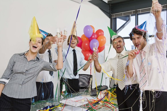 Businessmen celebrate at an office party.