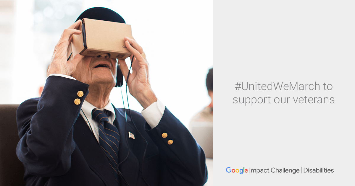 A man uses Google Cardboard virtual reality headset to view the Veterans Day Parade.