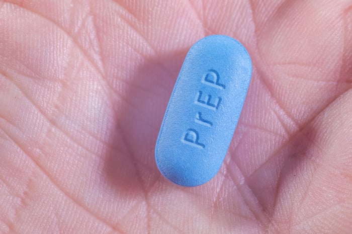 A blue "prep" pill that prevents the spread of HIV in the palm of a hand.