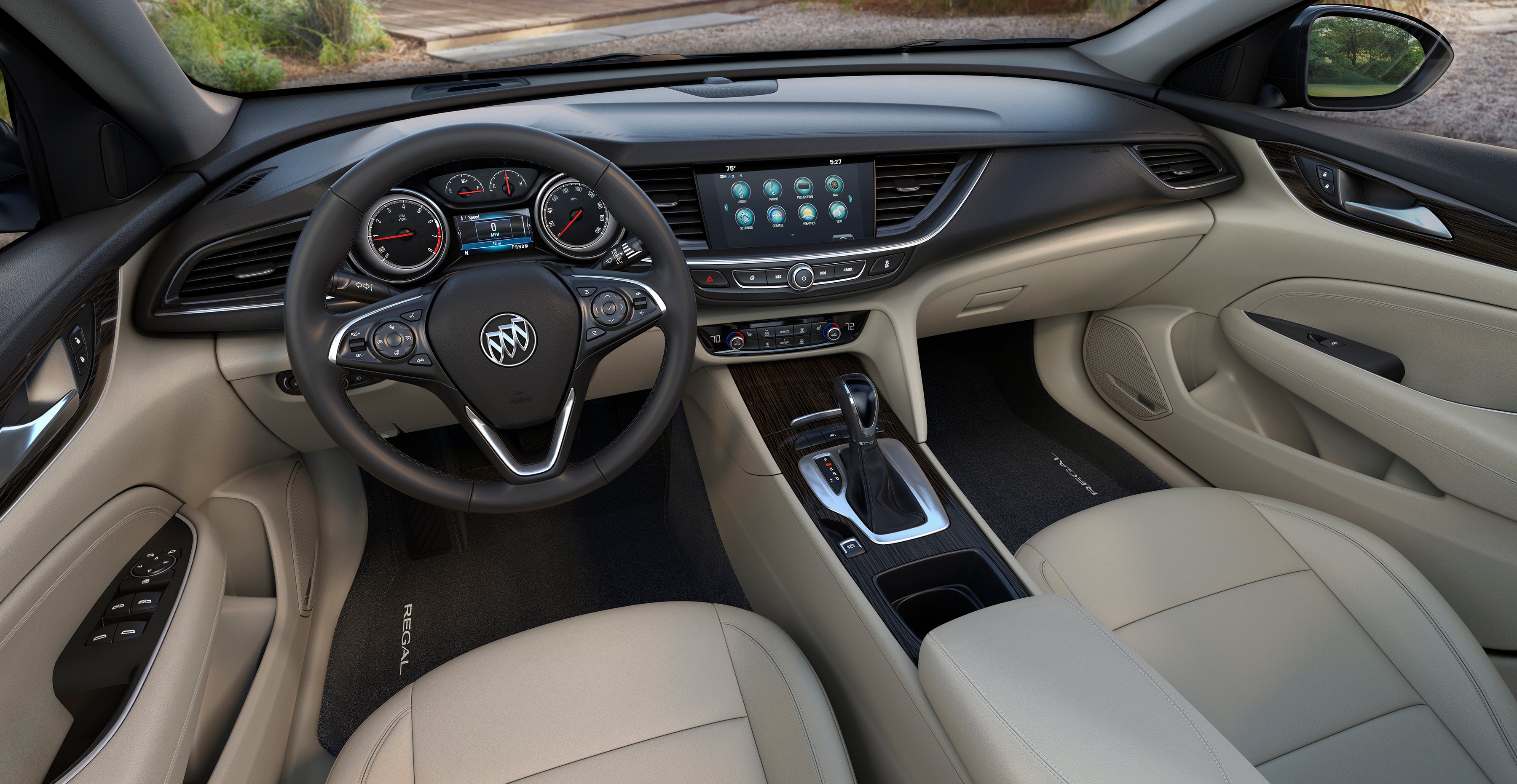 The front seat and dash of a new Buick Regal are shown.