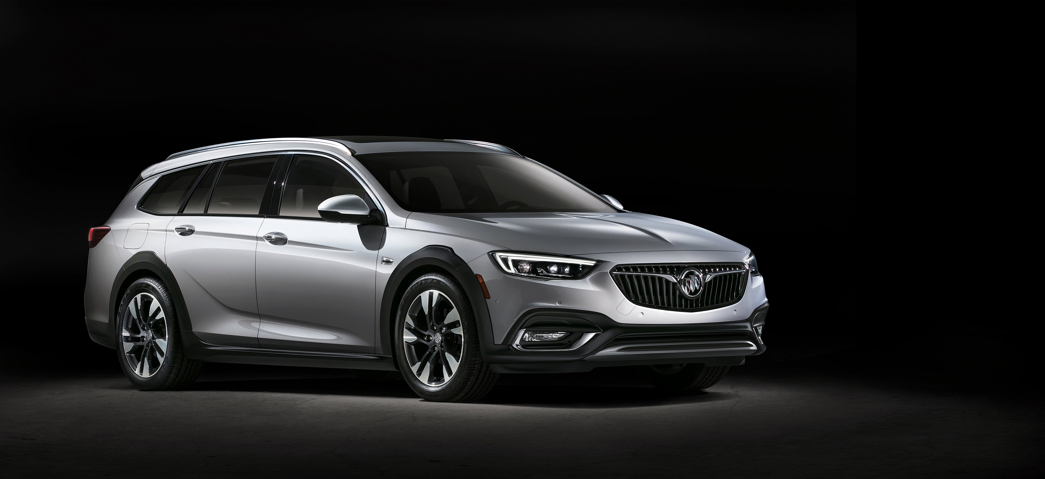 The Regal TourX, a rugged-looking wagon, is shown against a dark background.