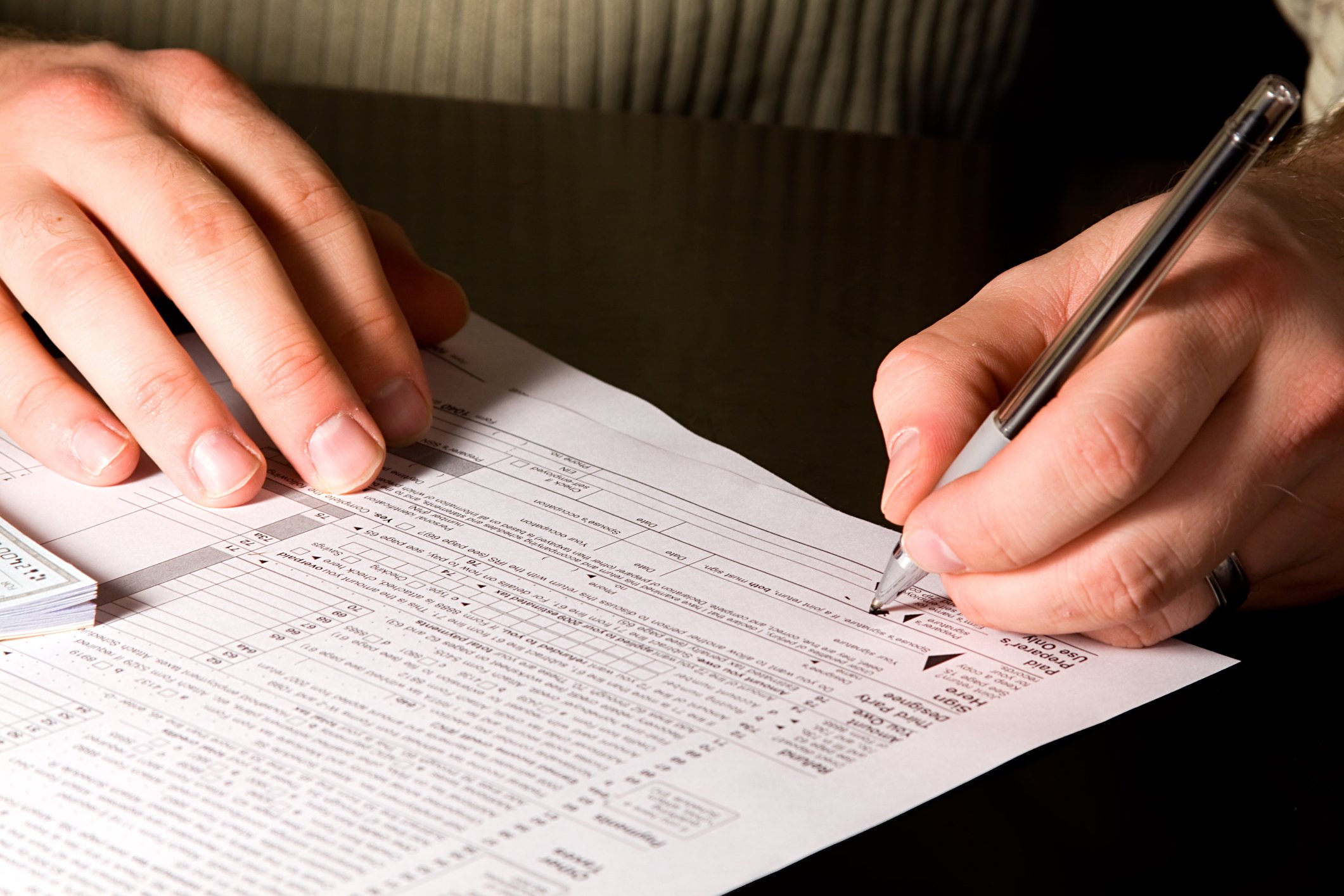 Person filling out a tax form