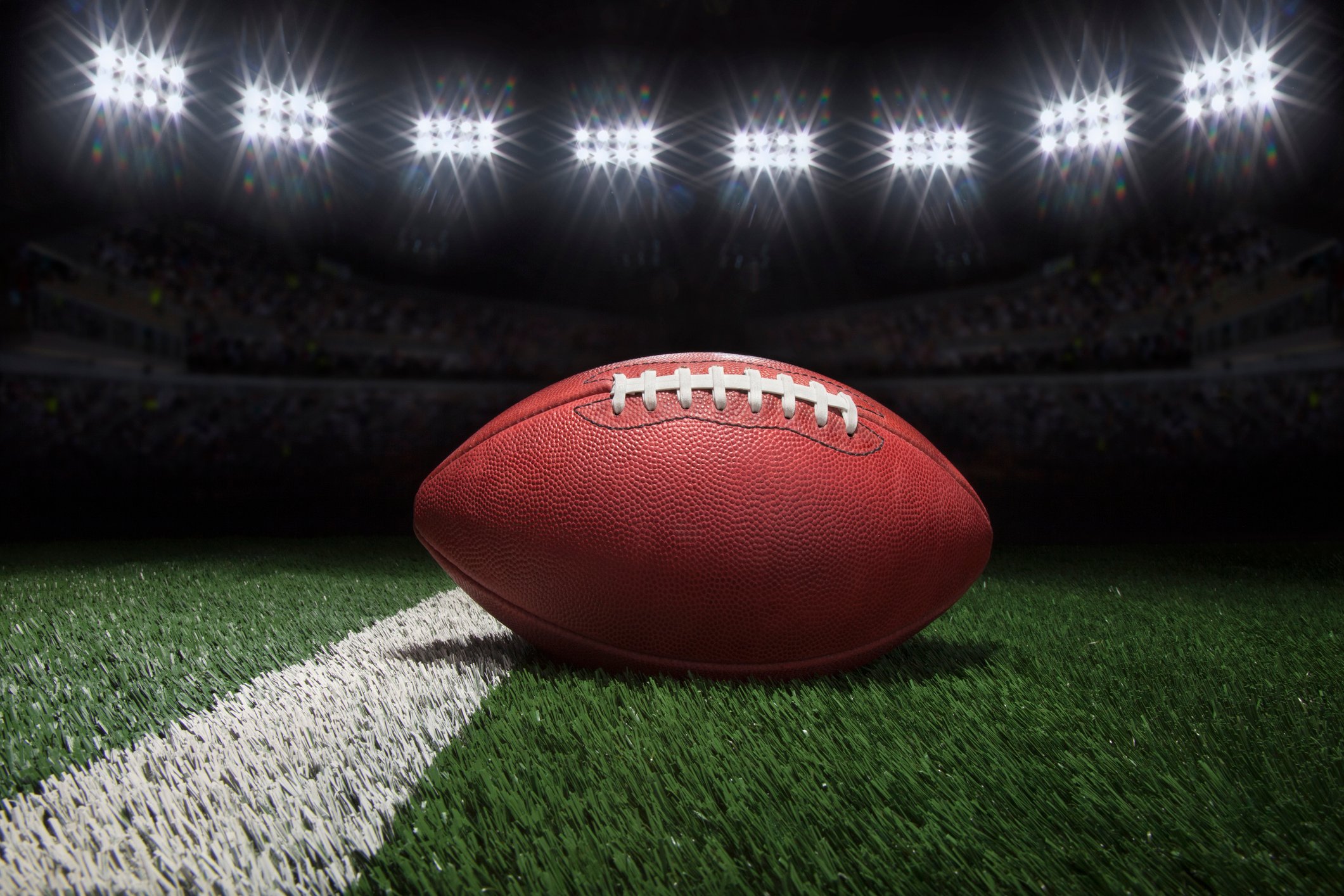 Football on Field Under Lights