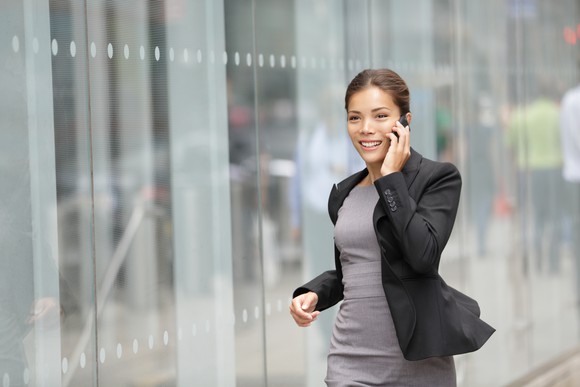 Businesswoman smiling and talking on the phone.