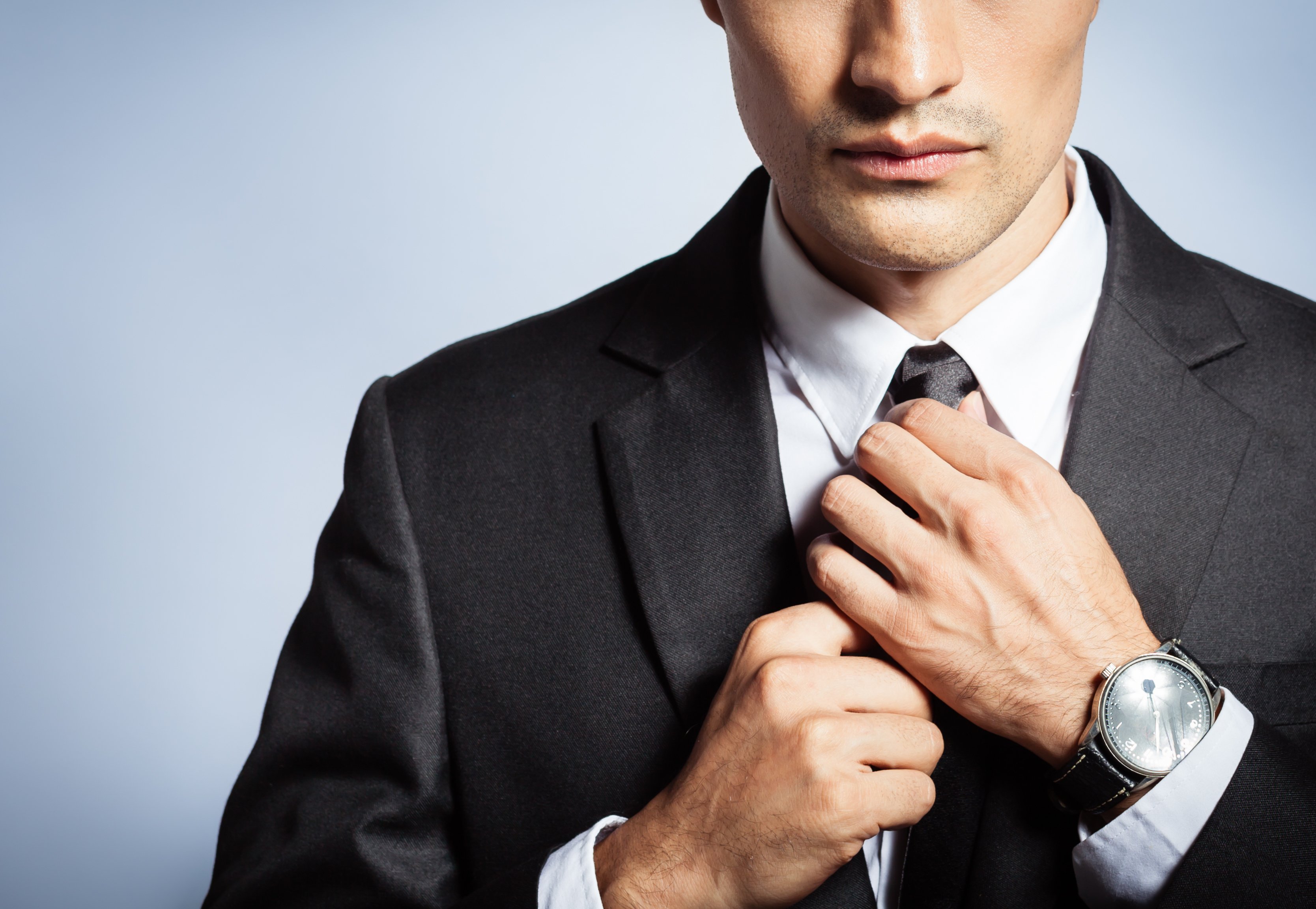 Businessman fixing his tie