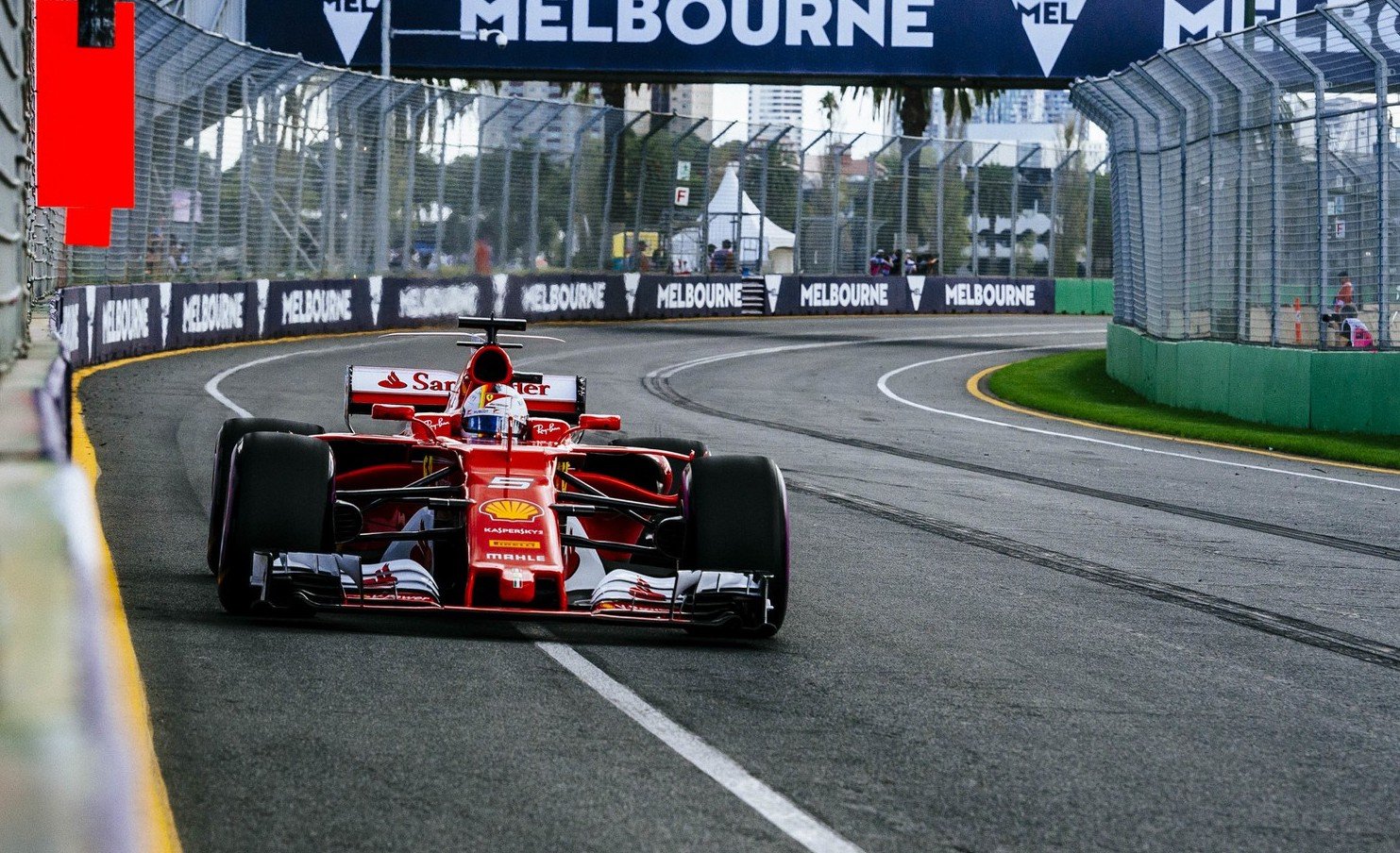 A Ferrari Formula One race car at speed on a racing track. 