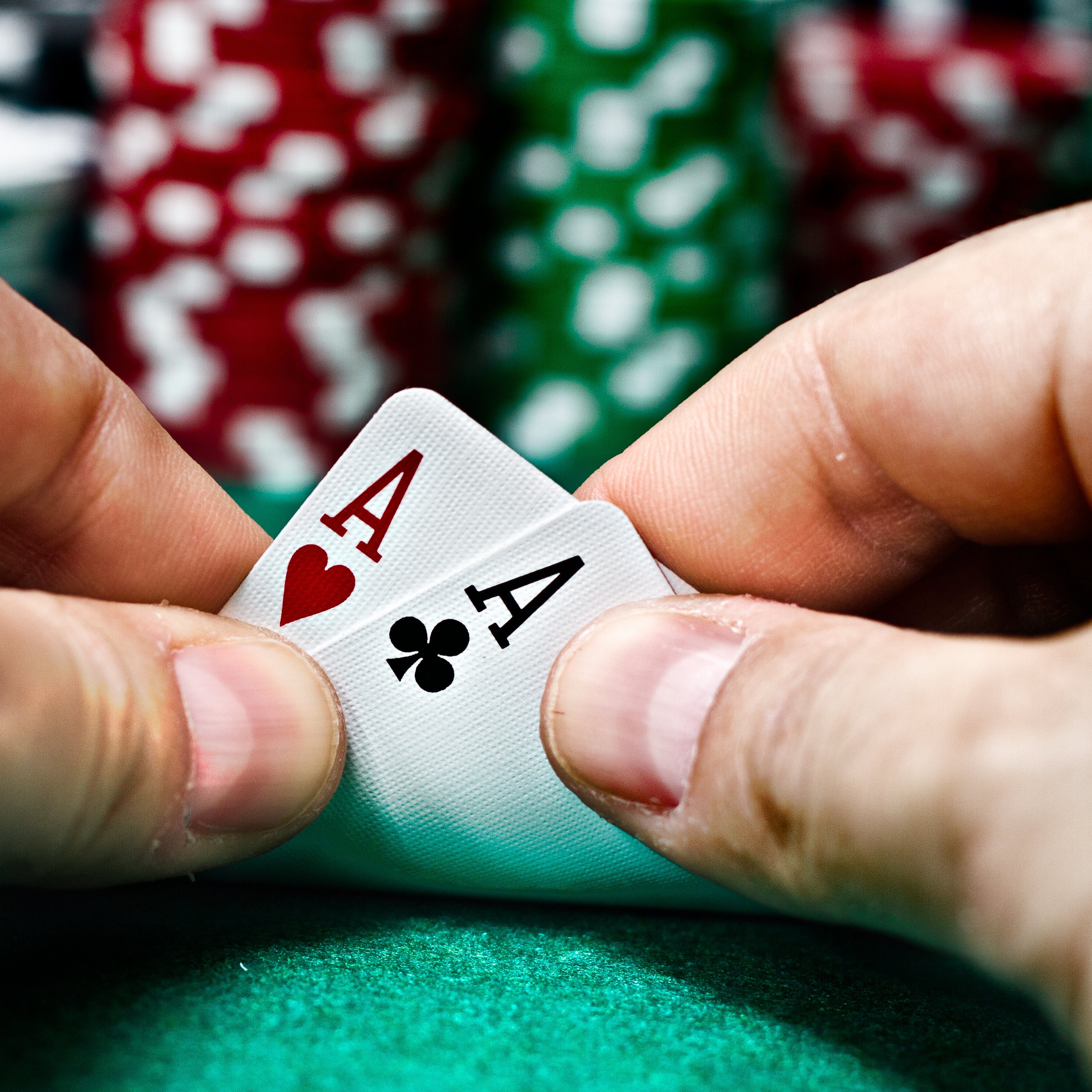 A poker player revealing that he/she has two aces.