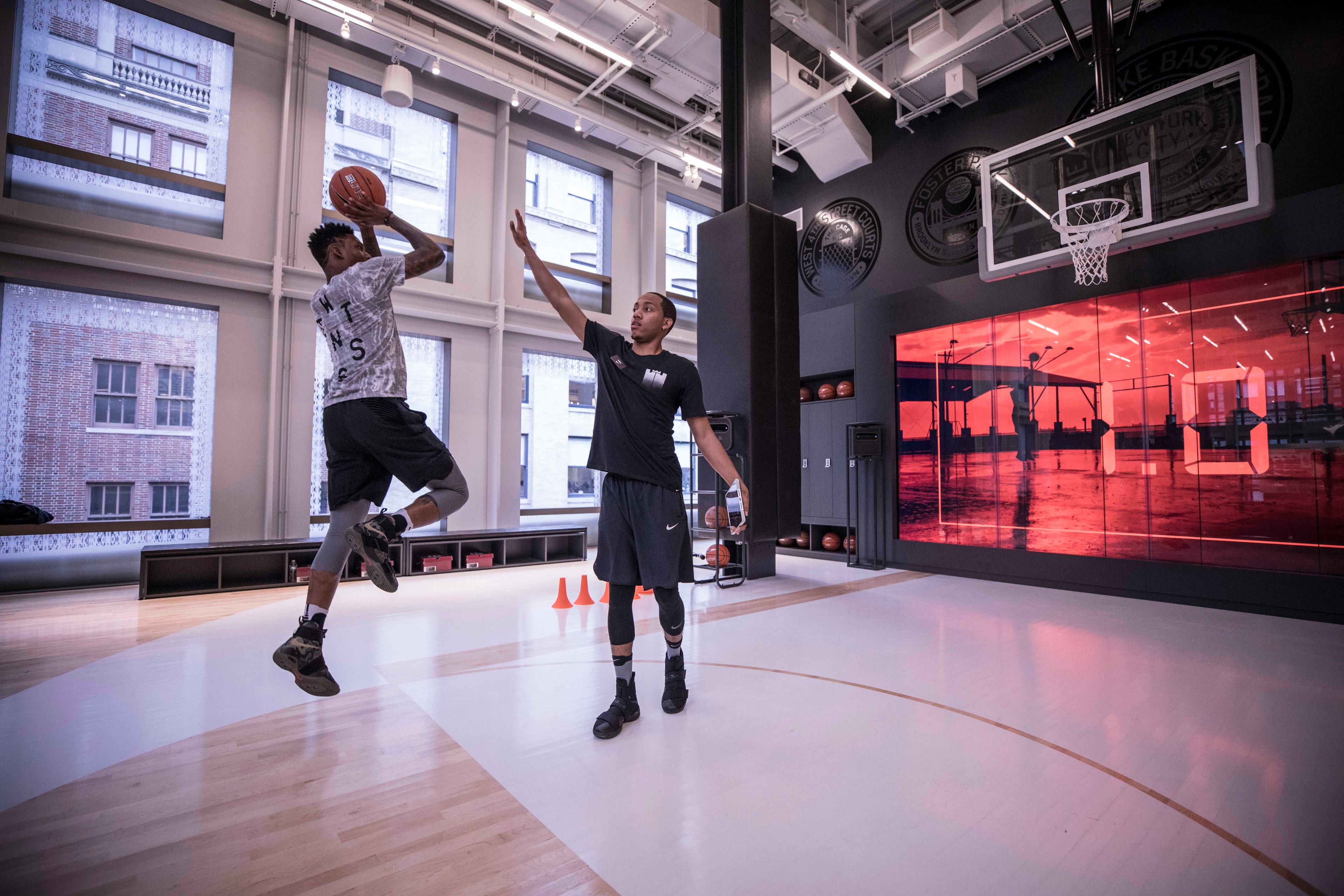 Players practice on the Nike store's basketball floor 