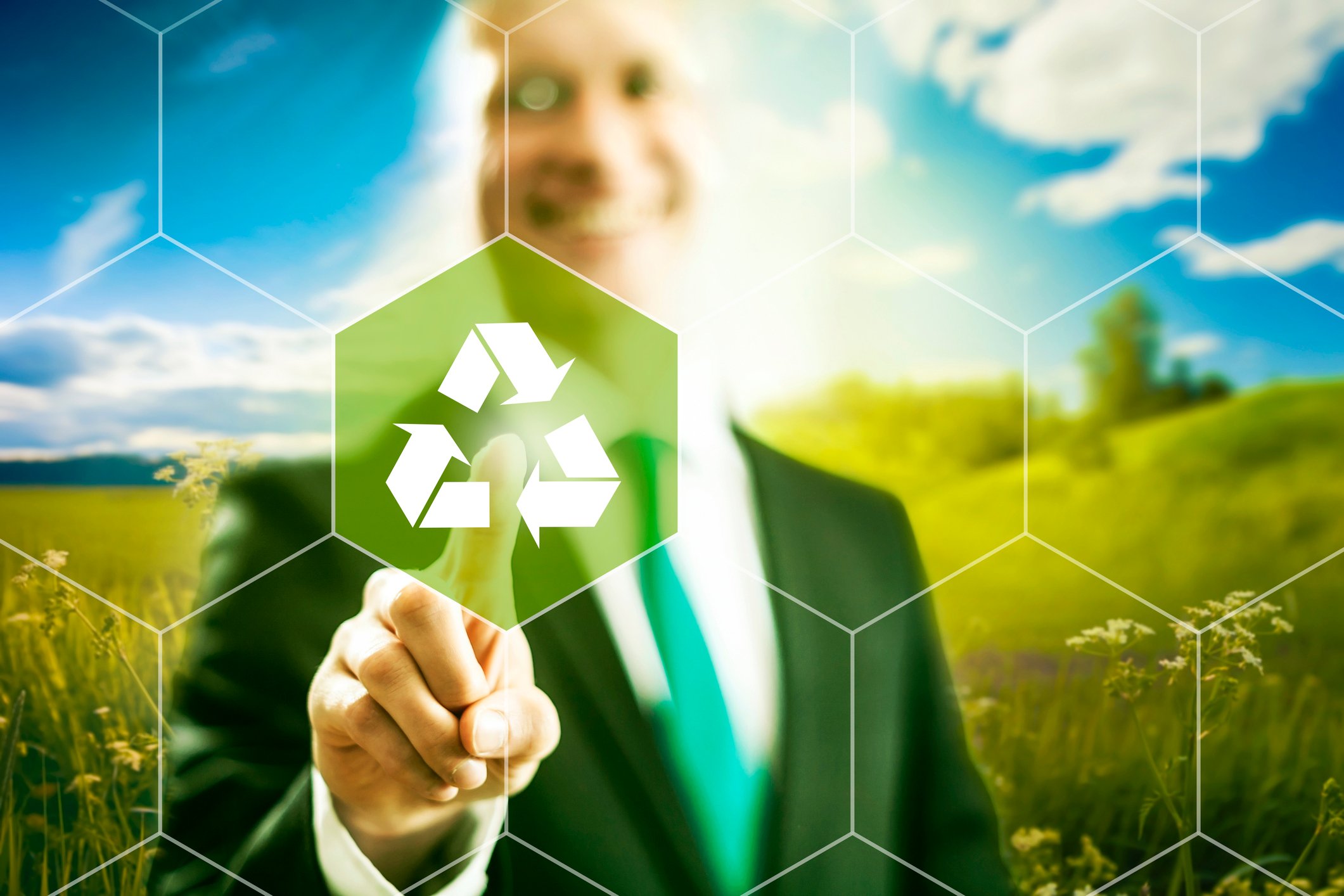 A man pointing with his finger to a recycling logo