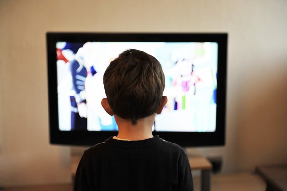 A boy watches TV