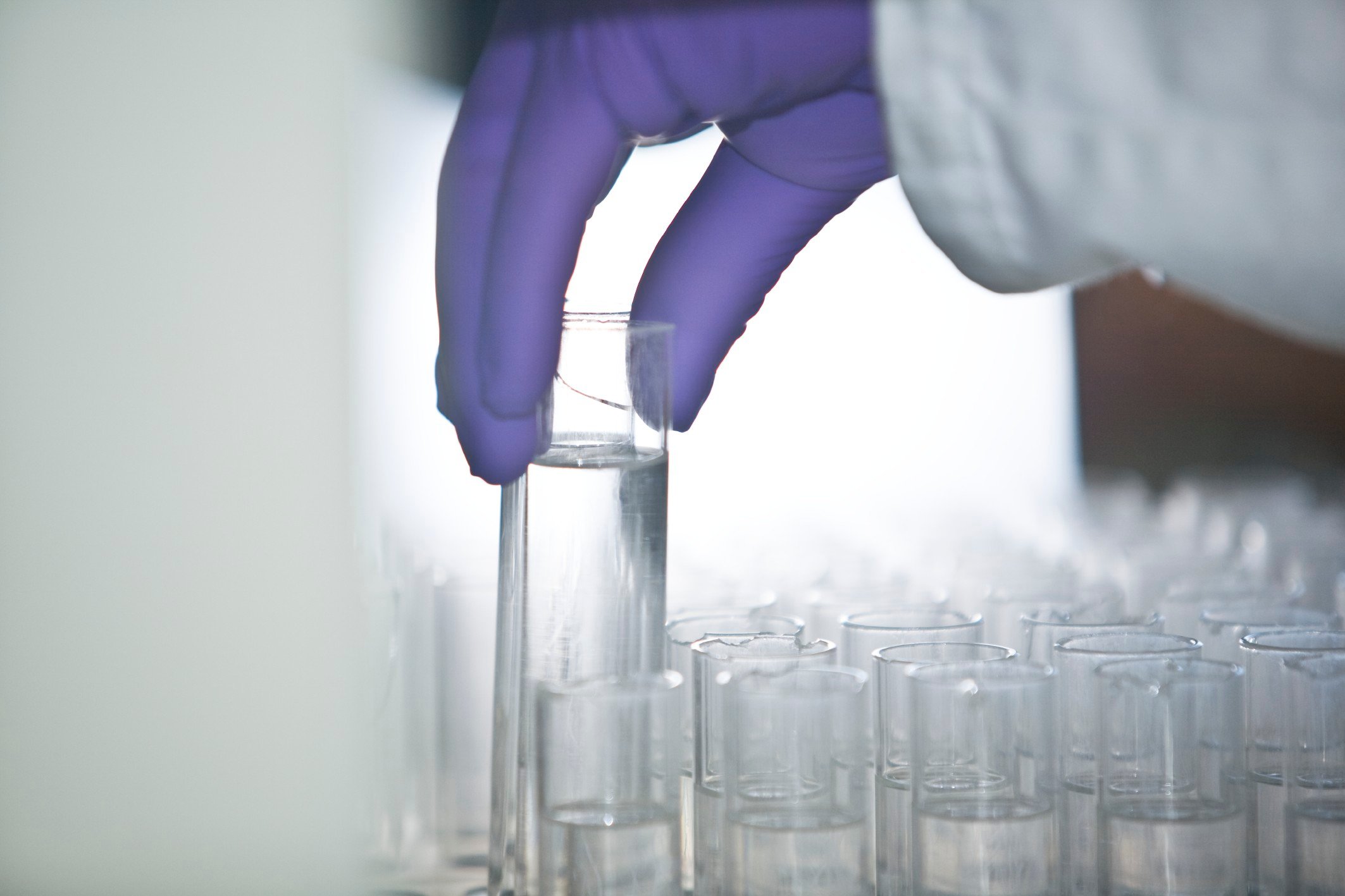 Chemist holding a vial of chemical.