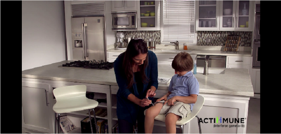 Mother giving Actimmune shot to child