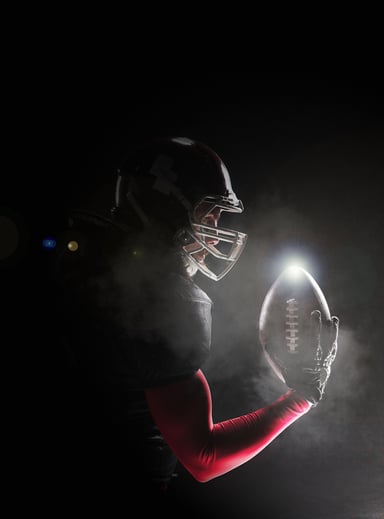 Football Player Posing With Ball
